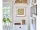 A bright entryway features artistic decor, indoor plant and a view from the window at 501 N Greensboro St, Carrboro, NC 27510