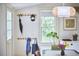 Bright entryway with a window view, peg rack coat storage and creative artwork at 501 N Greensboro St, Carrboro, NC 27510