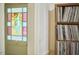 Entryway view of a stained glass front door adjacent to a record collection at 501 N Greensboro St, Carrboro, NC 27510