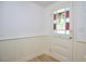 Entryway view of a stained glass front door with classic wainscotting and hardwood flooring at 501 N Greensboro St, Carrboro, NC 27510