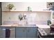Stylish kitchen featuring a stainless steel sink, open shelving, and modern design at 501 N Greensboro St, Carrboro, NC 27510