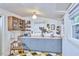 Bright kitchen featuring blue cabinets, stainless appliances, and geometric flooring at 501 N Greensboro St, Carrboro, NC 27510