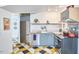 Eclectic kitchen showcasing modern appliances, light blue cabinets, and unique diamond flooring at 501 N Greensboro St, Carrboro, NC 27510