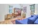 Comfortable living area featuring a blue couch, wooden desk, and unique decor items at 501 N Greensboro St, Carrboro, NC 27510