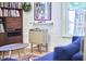 Bright living area featuring a bookshelf, guitar art, and vintage decor at 501 N Greensboro St, Carrboro, NC 27510