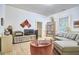 Cozy living room with hardwood floors, a comfortable sofa, and a well-stocked record collection at 501 N Greensboro St, Carrboro, NC 27510