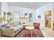 Bright living room featuring a plush sofa, decorative rug, and ample natural light at 501 N Greensboro St, Carrboro, NC 27510