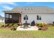 Well-kept backyard with a patio set, screened-in porch, and lush landscaping at 518 Spruce Meadows Ln, Willow Springs, NC 27592