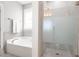 Bright bathroom with tub, separate shower and modern finishes at 518 Spruce Meadows Ln, Willow Springs, NC 27592