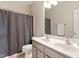 Well-lit bathroom featuring double sinks, a large mirror and shower/tub combination at 518 Spruce Meadows Ln, Willow Springs, NC 27592