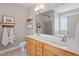 Bathroom featuring double sink vanity, tiled floor, large mirror, shelves and soft decor at 518 Spruce Meadows Ln, Willow Springs, NC 27592
