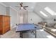 Spacious bonus room with ping pong table, comfortable seating, and natural light from skylights at 518 Spruce Meadows Ln, Willow Springs, NC 27592