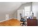 Large bonus room featuring hardwood floors, built-in storage, and a work desk near the window at 518 Spruce Meadows Ln, Willow Springs, NC 27592