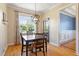 Bright dining room with wood floors, decorative lighting and views to the outdoor space at 518 Spruce Meadows Ln, Willow Springs, NC 27592