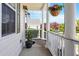 View of the inviting front porch with hanging flower baskets and a cozy, shaded ambiance at 518 Spruce Meadows Ln, Willow Springs, NC 27592
