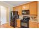 Functional kitchen showcases stainless steel appliances, ample cabinet space, and granite countertops at 518 Spruce Meadows Ln, Willow Springs, NC 27592