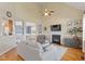 Bright and airy living room featuring a fireplace, hardwood floors, and elegant decor at 518 Spruce Meadows Ln, Willow Springs, NC 27592