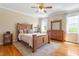 Spacious main bedroom with wood floors, neutral walls, fan and ample natural light at 518 Spruce Meadows Ln, Willow Springs, NC 27592