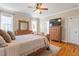 Comfortable main bedroom featuring hardwood floors, a ceiling fan and decorative furniture at 518 Spruce Meadows Ln, Willow Springs, NC 27592