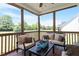 Cozy screened porch with comfortable seating and serene views of the surrounding landscape at 518 Spruce Meadows Ln, Willow Springs, NC 27592