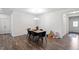 Minimalist dining room with modern light fixture and dark wood table set at 57 S Great White Way, Clayton, NC 27527