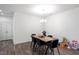 Dining area with minimalist table set beneath modern light fixture at 57 S Great White Way, Clayton, NC 27527