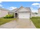 Charming single-story home featuring manicured landscaping and a two-car garage at 57 S Great White Way, Clayton, NC 27527