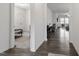 Bright hallway featuring hardwood flooring leading to a bedroom and living area at 57 S Great White Way, Clayton, NC 27527