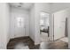 Bright hallway featuring hardwood flooring leading to a bedroom and bathroom at 57 S Great White Way, Clayton, NC 27527