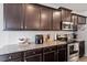 Close up of a kitchen featuring stainless steel appliances and dark wood cabinets at 57 S Great White Way, Clayton, NC 27527