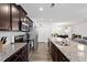 Open concept kitchen with stainless steel appliances, a granite countertop, and a view to the living area at 57 S Great White Way, Clayton, NC 27527