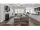 Open concept living area with fireplace and view of the modern kitchen at 57 S Great White Way, Clayton, NC 27527