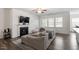 Bright living area with open concept, connected to the kitchen and fireplace at 57 S Great White Way, Clayton, NC 27527
