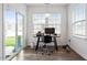 Bright office with hardwood floors, desk, rolling chair, and sliding glass doors offering abundant natural light at 57 S Great White Way, Clayton, NC 27527