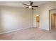 Spacious bedroom features neutral walls, carpet floors, ceiling fan and an en suite bathroom at 5742 Corbon Crest Ln, Raleigh, NC 27612