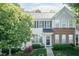 Charming townhome with a brick accent, flowering bushes and a well manicured lawn at 5742 Corbon Crest Ln, Raleigh, NC 27612