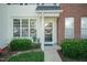 Close up of the front door with a welcome sign and manicured shrubs at 5742 Corbon Crest Ln, Raleigh, NC 27612