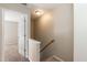 Hallway with carpeted stairs and an open doorway to a bedroom at 5742 Corbon Crest Ln, Raleigh, NC 27612