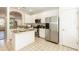 Bright kitchen features stainless steel appliances, tile floors, and granite countertops at 5742 Corbon Crest Ln, Raleigh, NC 27612