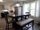A kitchen featuring a dining area with a dark table and white bench at 623 Glenwood Dr, Sanford, NC 27330