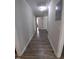 Hallway with hard wood flooring and neutral paint at 623 Glenwood Dr, Sanford, NC 27330