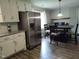 Modern kitchen with stainless steel refrigerator and adjacent dining area at 623 Glenwood Dr, Sanford, NC 27330
