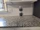 Close up of a dark kitchen counter with a set of decorative coffee cups at 623 Glenwood Dr, Sanford, NC 27330