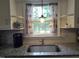 Kitchen sink in front of a window with stainless steel faucet and a plant at 623 Glenwood Dr, Sanford, NC 27330