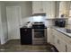 Featuring stainless steel appliances and white cabinets with dark countertops at 623 Glenwood Dr, Sanford, NC 27330