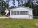 Exterior of a screened-in porch attached to the home, adorned with an American flag at 623 Glenwood Dr, Sanford, NC 27330