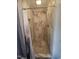 Tiled shower stall featuring stone floor, shower head, and shower curtain at 623 Glenwood Dr, Sanford, NC 27330