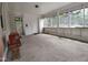 Large sunroom with a concrete floor, white paneling and many windows at 623 Glenwood Dr, Sanford, NC 27330
