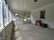 Bright and airy sunroom featuring a concrete floor, painted white paneling and lots of windows at 623 Glenwood Dr, Sanford, NC 27330