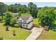 Aerial view of a beautiful home with lush green grass, landscaping, and a driveway at 6521 Cablewood Dr, Raleigh, NC 27603
